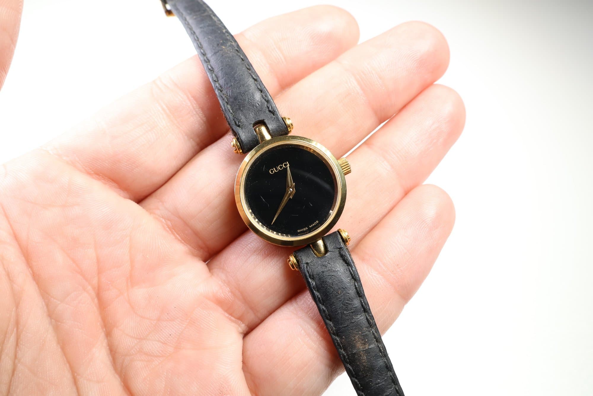 Gucci Gold-Tone Black Dial Leather Watch watches auction on bidia.ai
