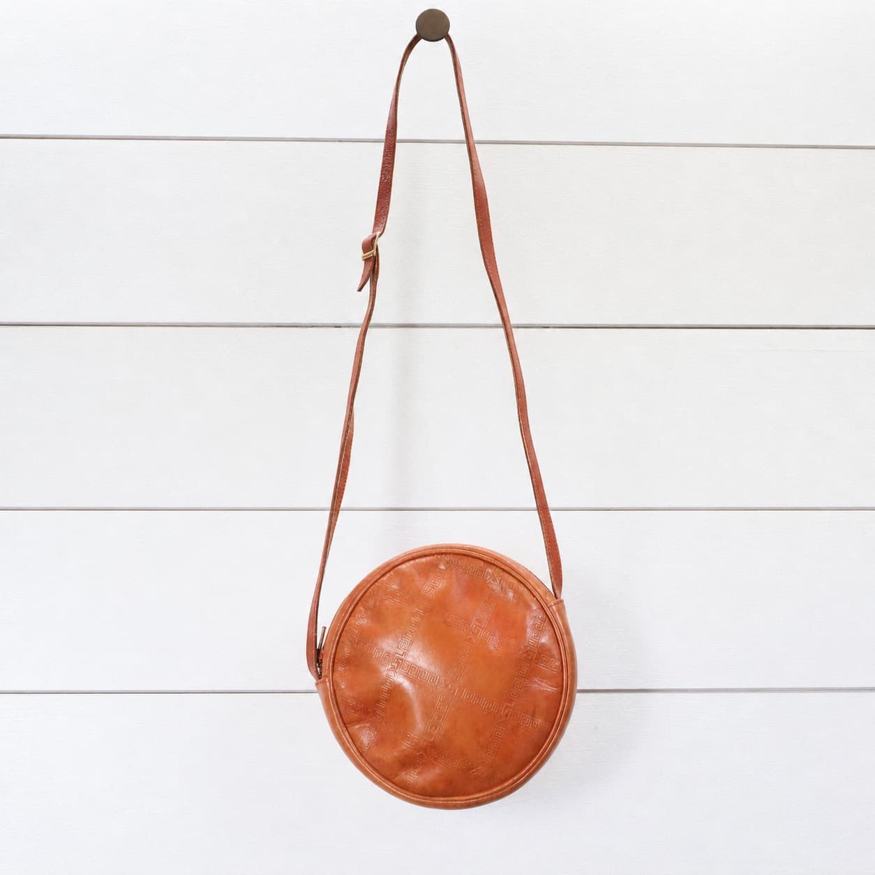 Yves Saint Laurent Embossed Logo Leather Round Crossbody Shoulder Bag Purse Tan handbags auction on bidia.ai